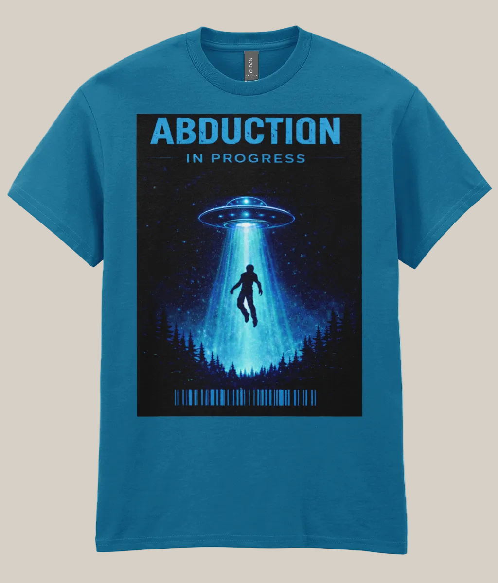 Blue t-shirt with a graphic of a UFO and silhouette of a person under a beam of light, labeled 'Abduction in Progress' on a white background.