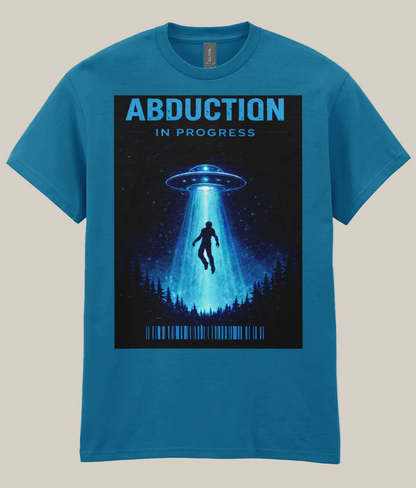 Blue t-shirt with a graphic of a UFO and silhouette of a person under a beam of light, labeled 'Abduction in Progress' on a white background.