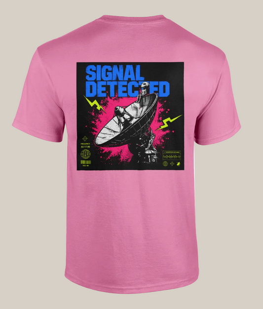 Pink t-shirt with a graphic design on the back featuring a satellite dish and text 'Signal Detected' on a white background.